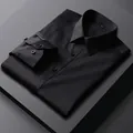 Detailed macro shot of a folded black long-sleeved men's business dress shirt - 38 / Tops / Black