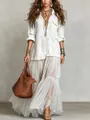Full-length shot of a white bohemian retro denim-style maxi dress with chic pockets - White