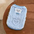 Detailed macro view of a light blue plush pet winter vest featuring a D-ring and heart pattern - M / Blue Heart Jacquard