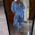 Detailed view of women metallic blue long sleeve top and pants set with eye print - Blue