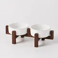 Elevated ceramic cat bowl set with paw print pattern and dark wood stand - Small Embossed Paw Bowls + Dual Acacia Wood Stand