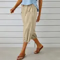 Detail of women's khaki linen cropped pants with drawstring waist and buttoned hem. - S / Bottoms / Khaki