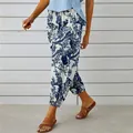 Close-up detail of women's vintage blue floral print cotton linen high waist pants - S / White
