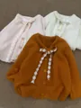 Cardigan in maglia con fiocchi e pizzo floreale in rosa, bianco e arancione. - Taglia unica (40-62.5kg) / Top / Arancione