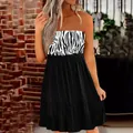 Detail view of a stylish zebra print tube dress with a tiered pleated black skirt - Zebra Pattern Print