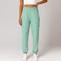 Detail view of light green high-waisted joggers with a side zipper pocket and elastic cuffs - S / Bottoms / Light Green