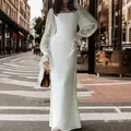 Full view of elegant white long sleeve U-neck mermaid wedding dress in urban street - S / Dresses / White