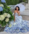 Detailed view of an elegant off-shoulder floral organza evening gown in a garden - S / Dresses / Blue