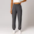 Close-up detail of dark grey high-waisted joggers featuring a functional zippered side pocket - S / Bottoms / Gray