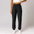 Close-up of black cuffed sweatpants with elastic waist and side zipper pocket detail. - S / Bottoms / Black