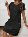 Close-up of black cotton linen dress featuring zipper neckline and decorative buttons - S / Dresses / Black