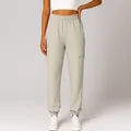Detailed view of high-waist beige joggers featuring a functional side zipper pocket - S / Bottoms / Apricot