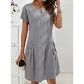 Detail view of cotton linen dress featuring zipper neckline and decorative pocket buttons - S / Dresses / Gray