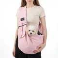 Close-up detail of a pink quilted pet sling carrier with a small white dog inside - Pink