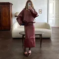 Elegant burgundy faux leather jacket and midi skirt two-piece set in a cozy home setting - S / Top And Bottom / Burgundy