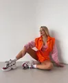 Detail view of vibrant orange and pink color-block women's sports set with zipper - Orange Pink Patchwork