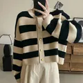Detail of striped knit cardigan for women with elegant gold buttons and black beige pattern - One Size / Tops / Black