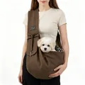 Model demonstrating a brown quilted pet sling carrier bag with a small white puppy - Coffee