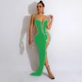 Detailed view of an elegant green evening gown with sparkling rhinestones and mesh inserts - Green