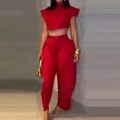 Detailed view of vibrant red two-piece set with crop top and high-waisted trousers - XS / Top And Bottom / Red