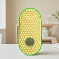 Oval green cat self-grooming brush with yellow honeycomb surface and embedded catnip ball - Yellow