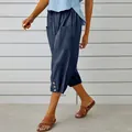 Navy blue cotton linen cropped pants with drawstring waist and button hem details - Navy Blue