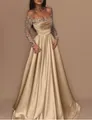 Elegant champagne gold evening gown with long sequined sleeves and pleated satin skirt - S / Dresses / Gold