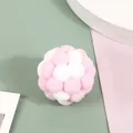 Detailed close-up of a pink and white plush pom-pom cat toy ball showing soft texture. - Pink White
