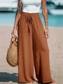 Detailed view of high-waist brown wide-leg pants styled for beach vacations - 2XL / Bottoms / Tan
