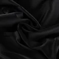 Close-up detail of black satin fabric with elegant glossy finish and soft folds - S / Tops / Black