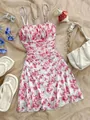 Floral ruched cami dress with stylish vacation accessories on a neutral beige fabric backdrop - S / Dresses / Pink