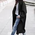 Professional model wearing a stylish long black wool coat in urban street setting - M / Tops / Black