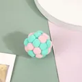 Macro view of colorful plush pom-pom cat toy ball featuring pink and mint green tones - Pink and Green