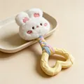 Close-up detail of plush rabbit dog toy with heart-shaped rubber teether and braided rope. - White Rabbit Style