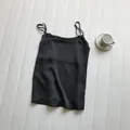 Close-up of a black satin camisole with thin adjustable straps on white background - M / Tops / Black