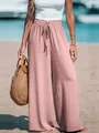 Close-up detail of women's pink wide-leg trousers featuring a smocked elastic waist and drawstring - Pink