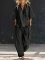 Woman wearing a stylish dark grey linen-style two-piece casual set in urban setting - S / Top And Bottom / Black