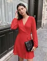 Elegant red V-neck wrap dress with puff sleeves and tie waist shown in an outdoor setting - S / Dresses / Red
