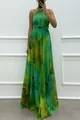 Detail of a green printed halter maxi dress showing the flowy fabric and elegant fit. - S / Dresses / Green