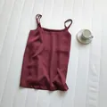 Elegant maroon satin camisole with adjustable thin straps on white textured background - M / Tops / Burgundy