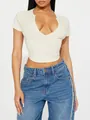 Detail view of a sexy cream ribbed crop top featuring a deep V-neckline for women - S / Tops / Apricot