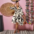 Full length view of a women's long sleeve shirt dress with bold black abstract patterns - Khaki