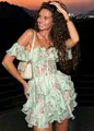 Detail of tiered floral ruffle dress with off-shoulder neckline on beautiful model - S / Dresses / Pale Green