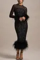 Close-up of elegant black sequined party dress with feather cuffs and hem detail - S / Dresses / Black