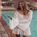 Close-up detail of a white crochet beach cover-up dress with flared bell sleeves and lace pattern - S / Dresses / White