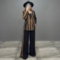 Detailed view of elegant brown and black striped blazer with matching wide-leg trousers. - S / Top And Bottom / Black & Brown Striped