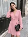 Detail view showing the elegant pink V-neck wrap dress with puff sleeves and tie waist - S / Dresses / Pink
