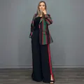 Elegant women's two-piece suit featuring red and green striped blazer and wide-leg pants. - Black and Red Striped
