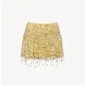 Macro view of glittering golden sequin tassel fringe on a luxury yellow mini skirt - S / Bottoms / Yellow