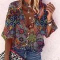 Close-up of bohemian blouse with vibrant mandala print and button-down V-neckline - S / Tops / Geometric